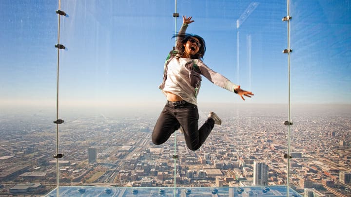 Woman jumping for joy at the Skydeck in Chicago